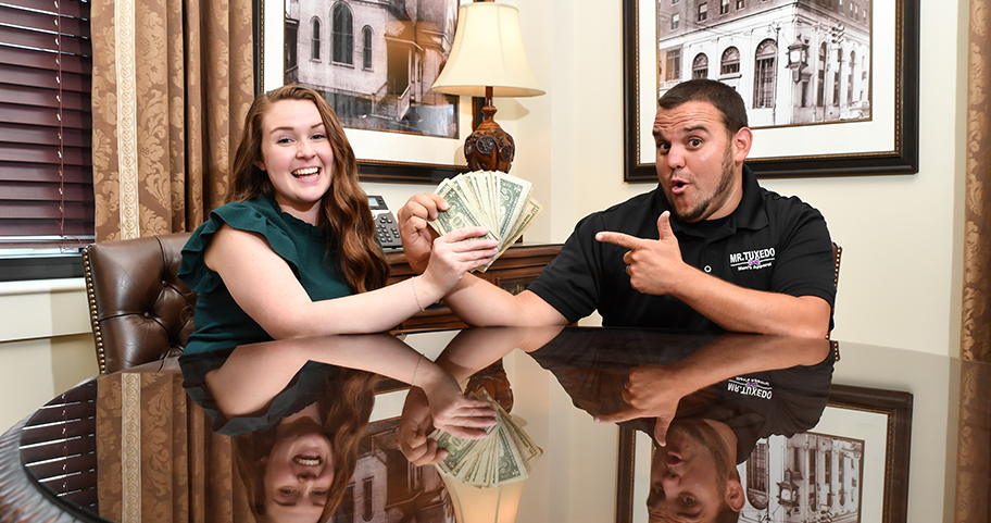 Two people having fun showing off money